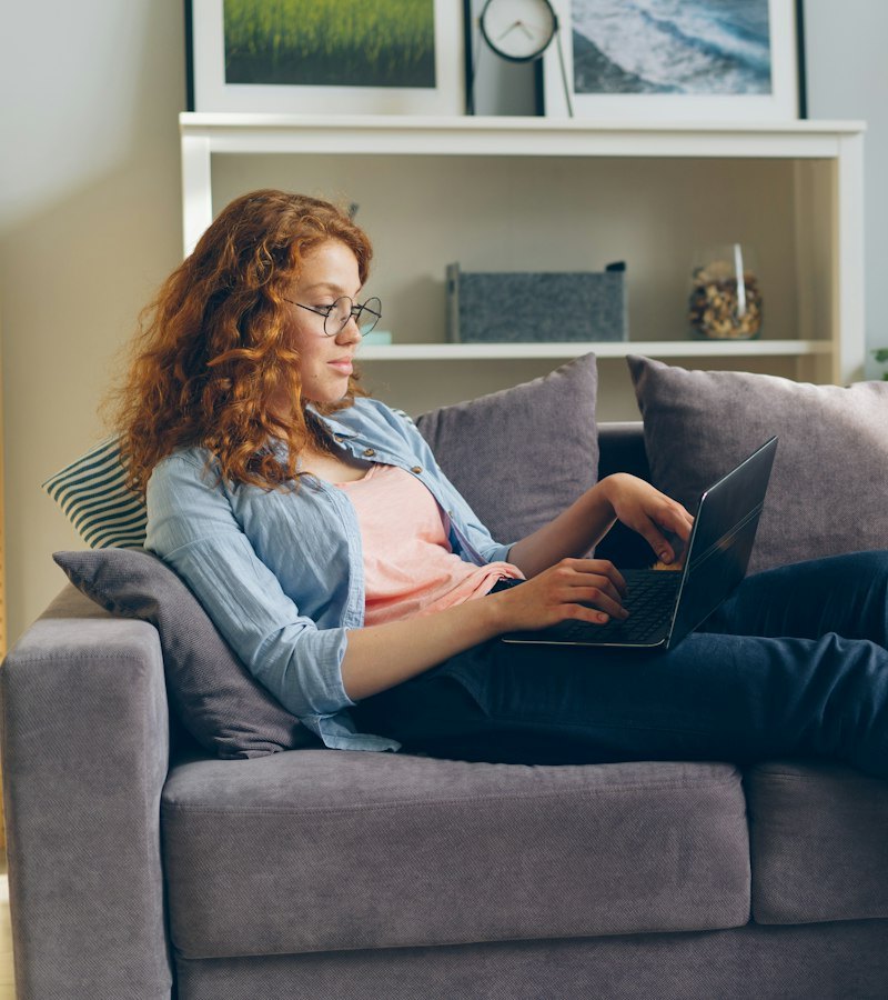 Woman reading wellness tips on her laptop